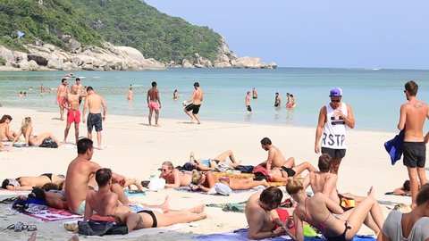 KOH PHANGAN,THAILAND - DECEMBER 14, 2016 : Haad Rin beach before the full moon party. Unidentified girls and guys arrived on the island of Koh Phangan, to participate in the Full Moon party