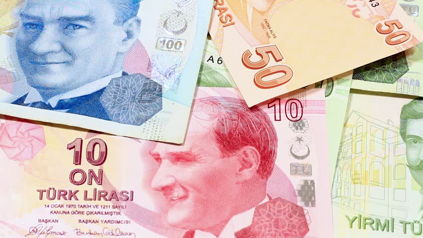 Losing Money. Reverse motion of Turkish banknotes falling against white