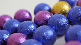 Christmas chocolate treats wrapped in cellophane slow pan 3840X2160 UltraHD footage - Panning over colorful candies close-up 4K 2160p 30fps UHD video