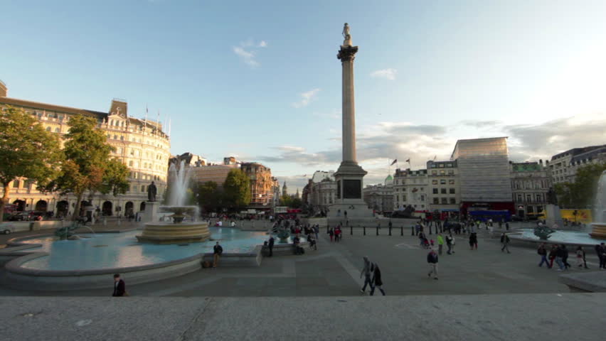 Tilt shot of Trafalgar Square - fountains, people, and Lord Nelson's monument -