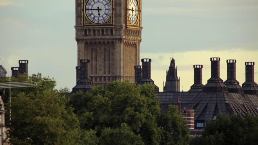Big Ben dial with treetops and chimneys