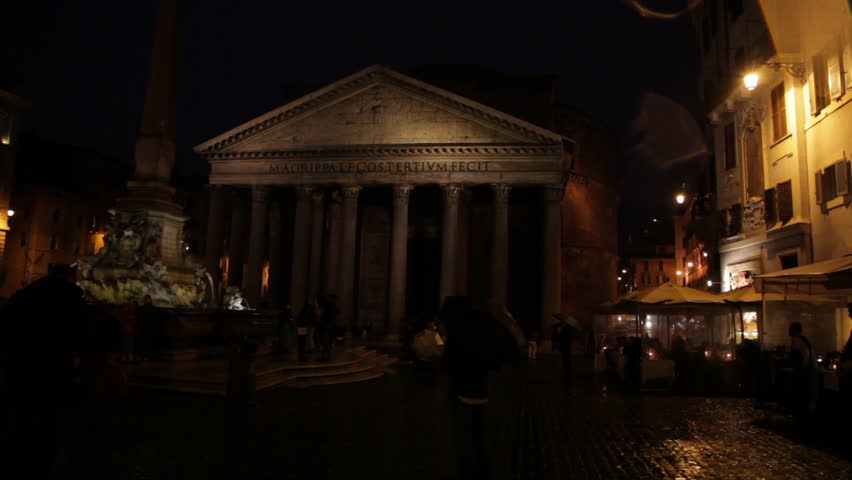 Silhouettes of tourists visiting the Pantheon at night. Intriguing lighting