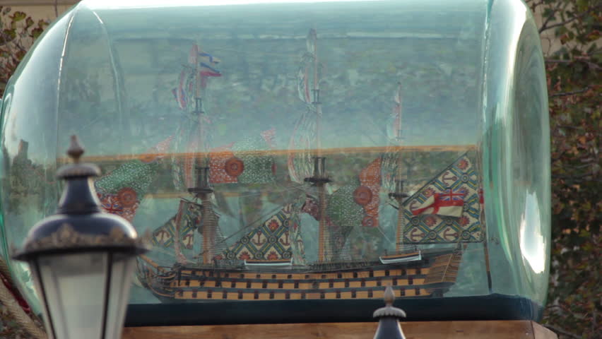 Panning shot, right to left, of a ship inside a bottle, a replica of admiral