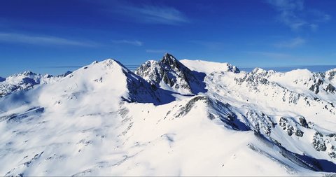 Flight Over Mountain Summit With Snow - Aerial View