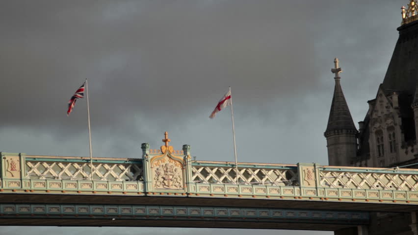 Top view of the Tower Bridge, shows the two British flags waving in wind on top,