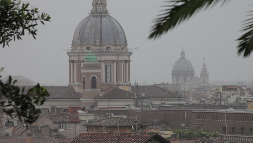 Footage of Roman rooftops and the ornate architecture of several domed buildings