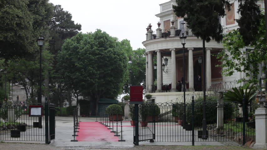 Red carpet leading to a Roman buiding