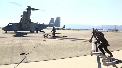 The United States - August 12, 2015: Group of U.S. marines refueling a tilt rotor aircraft