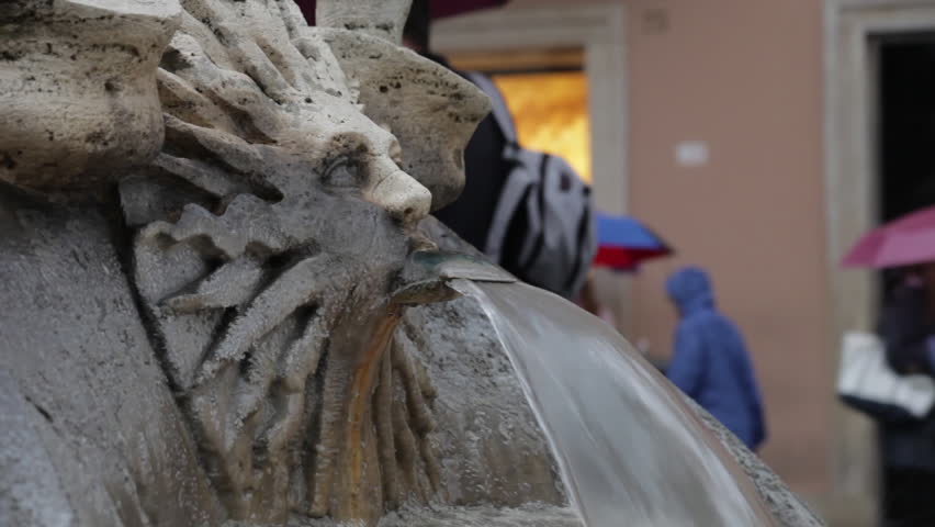 Close-up shot water flowing off of the Fontana della Barcaccia sun sculpture