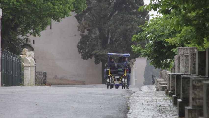 Tourists take a ride in a Roman rickshaw on rainy day