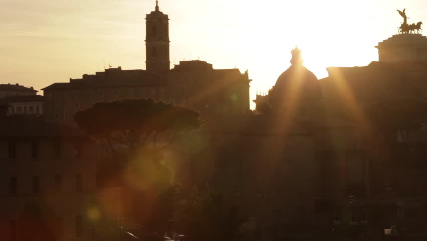 The sun sets over the buildings that surround the Roman Forum