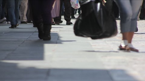 Time lapse video of feet of people walking in the city