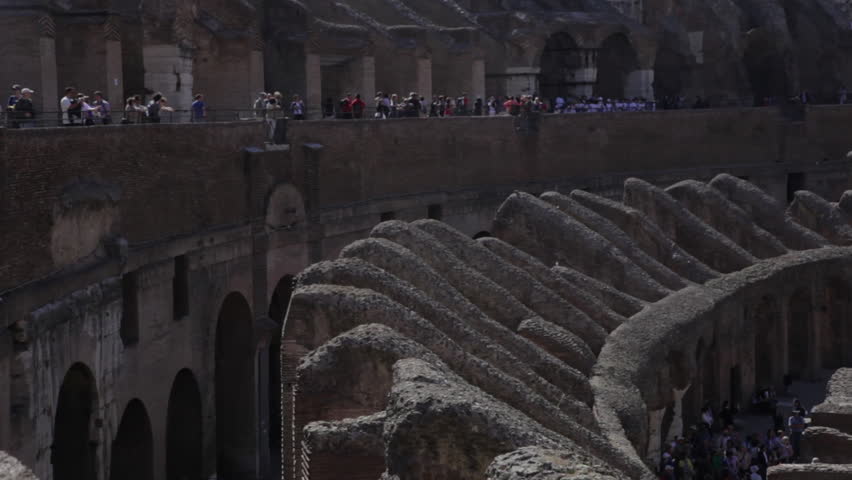 Tourists seen walking around various areas of the Colosseum.