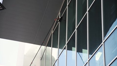 professional window cleaning. washing the exterior windows of high building 