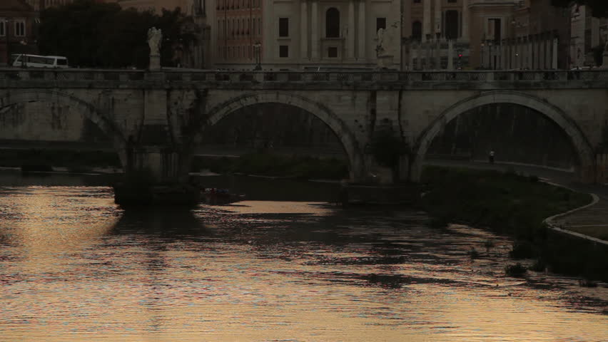 Footage of the east side of the Ponte Sant'Angelo during an orange sunset.