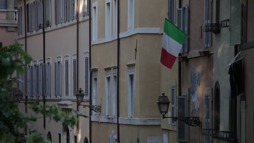 Walls covered in windows and lamps. A Italian flag hangs from the wall.