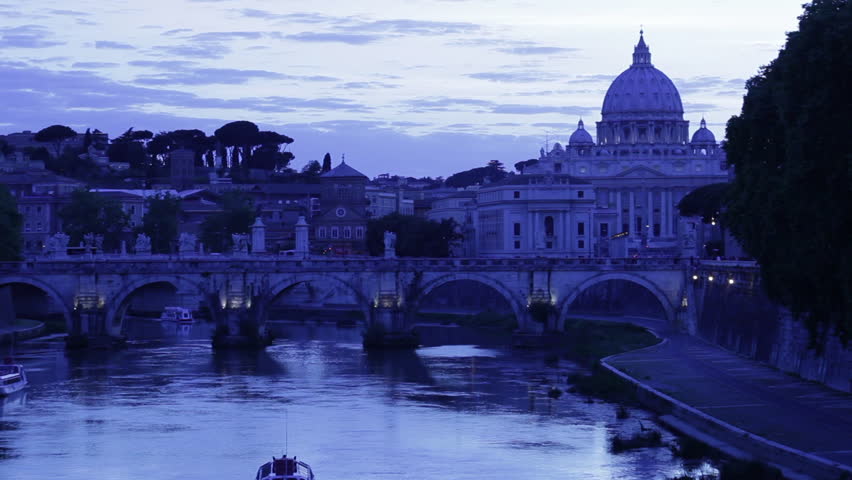 Boat moving along The Grand Canal with San Pietro in the background at dusk