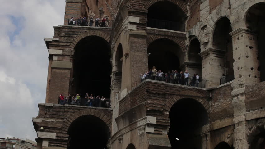 Shot looking up at the tourists on the outside balconies of the Colosseum.