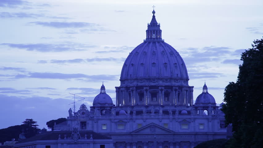 Close up shot of San Pietro dome at dusk with clouds and sky in the background