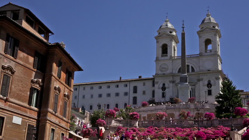 Low angle footage of the obelisk and towers of the Trinita dei Monti from the