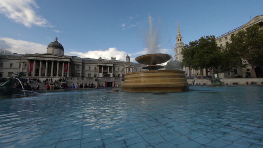A stationary shot of National Gallery (London) seen from a fountain. People are