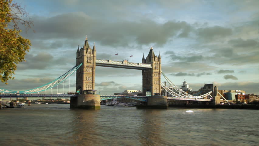 Distant slow motion view of Tower Bridge on Thames River in London, England.