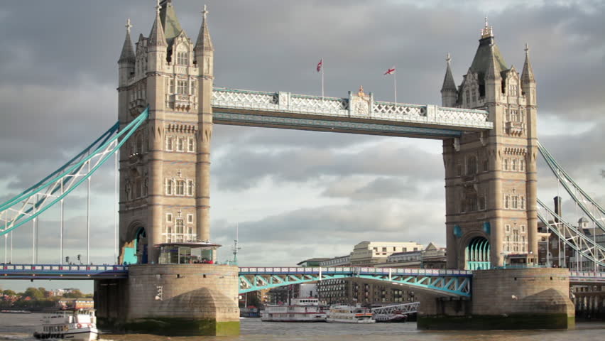 Stationary shot of Tower Bridge, white ship on the left, located in London,