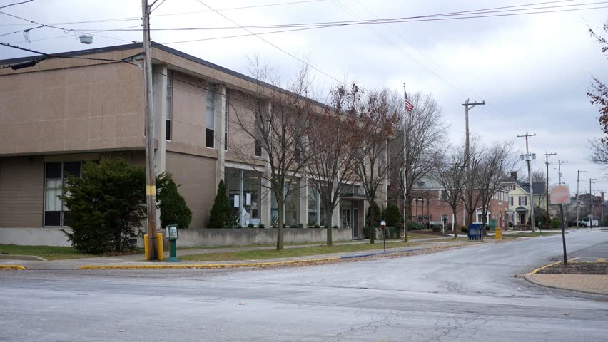Local Mail building on the corner of street in suburban community in winter