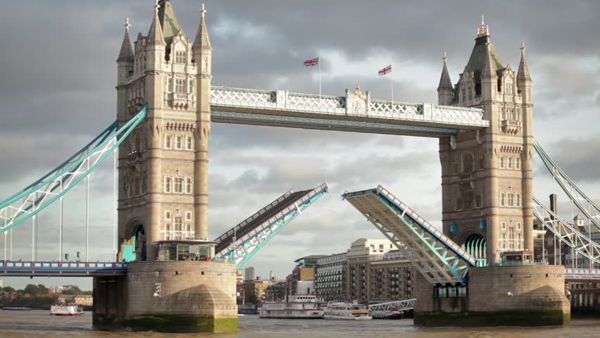 Bascules raise on Tower Bridge in London, England.