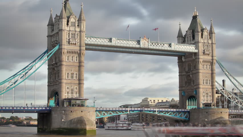 Time lapse of the Tower Bridge bascules raising, boats pass under, located in