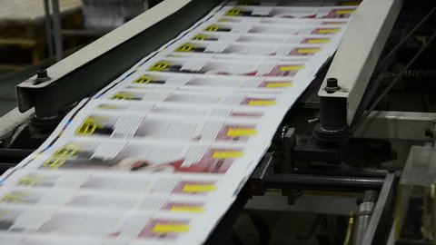 print plant factory, magazine line collecting after passing the press rollers into printing units and folder