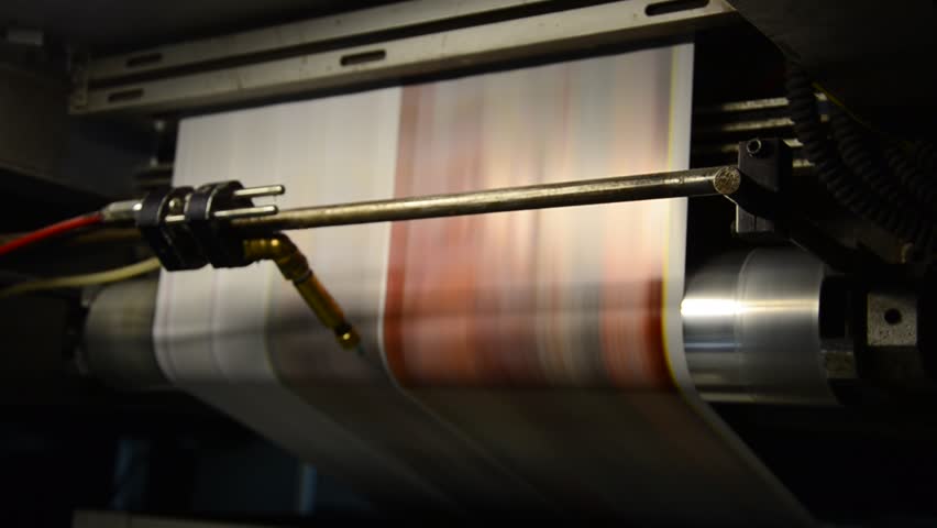offset print press hit set roll paper goes through the rollers and is read by