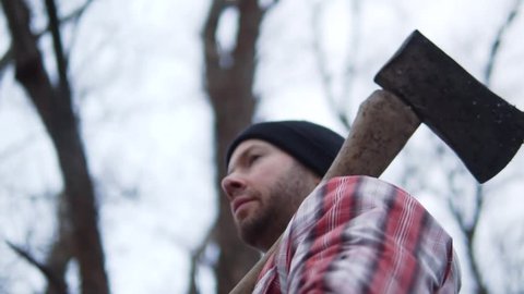Cinematic Lumberjack Man, Strength And Dedication, Outdoor Snow Slow Motion. Authentic Candid Heroic Looking Low Angle.
