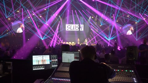 HELSINKI, FINLAND - NOVEMBER 30, 2017: Director of show manages sound and light with mixing console. Startup and tech show Slush Non-profit event for entrepreneurs, investors, students.