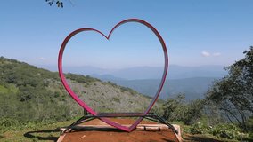 aerial tour with drone passing inside a huge red heart next to a beautiful gorge and revealing the amazing landscape of mountains of hidalgo - Powered by Shutterstock - Get 15% off with code: PIKWIZARD15