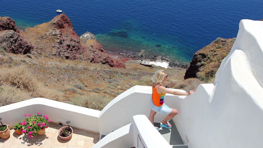 Woman with white washed walls and steps provide access to picturesque villages.