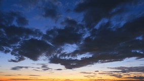 4K : Sunrise sky timelapse, Majestic sunrise: The sky transforms from inky darkness to a burst of warm hues as fluffy clouds race across, painting a breathtaking masterpiece. Summer time-lapse sky.
