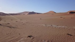 4K high quality aerial video scenic drone view of famous endless sand sea and Sossusvlei Namib Desert red sand dunes on sunny morning in Namib-Naulkuft Park in Namibia, southern Africa