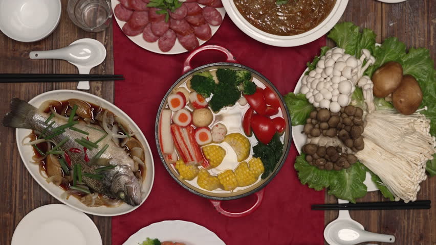 Vertical Screen: zoom in with view from above traditional lavish dishes for chinese lunar new year reunion dinner celebration