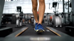 Exercise, shoes and a person walking on a treadmill for cardio training at gym for health or wellness Fitness, feet and athlete in a sports center