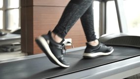 Treadmill workout, Walking Close-up Legs Adult male in sneakers walking on a Running machine footage concept gym for health or wellness