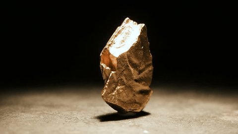 Closeup of a big gold nugget, slow motion footage