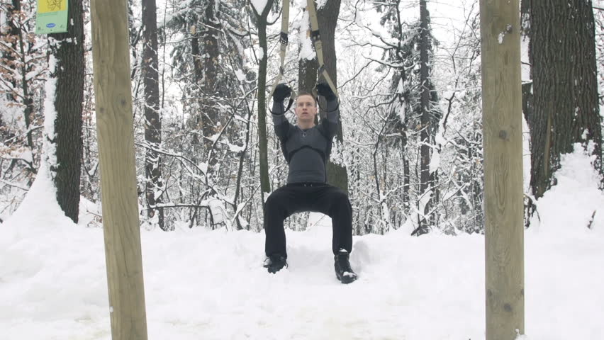 Slow Motion Of Young Sportsman Performing Suspension Training In Nature Covered