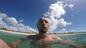 Video-selfie of underwater swimming in the Caribbean sea - young man with beard 