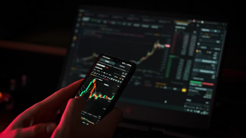 Crypto businessman working with stock market data graph on a smartphone. Man investor checking cryptocurrency on mobile phone app. Trader analyzing online BTC price on exchange graph. Buy Bitcoin Royalty-Free Stock Footage #3387160507