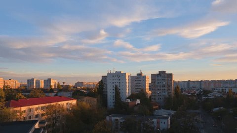 Day to night timelapse of Eastern Europe apartment buildings and city lights, with sunset clouds clearing for a black night sky. Arkivvideo