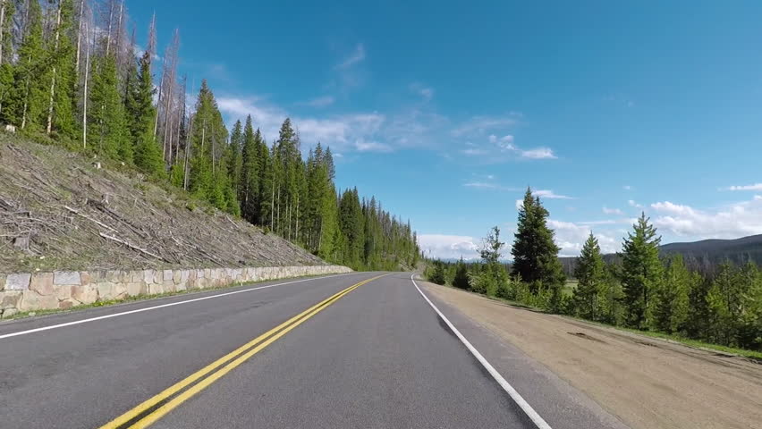 Meadow Rocky Mountain National Park drive POV. Rocky Mountain National Park near Denver on Continental Divide. Mountains, alpine lakes, tundra, forests and wildlife. 5 million visitors a year.