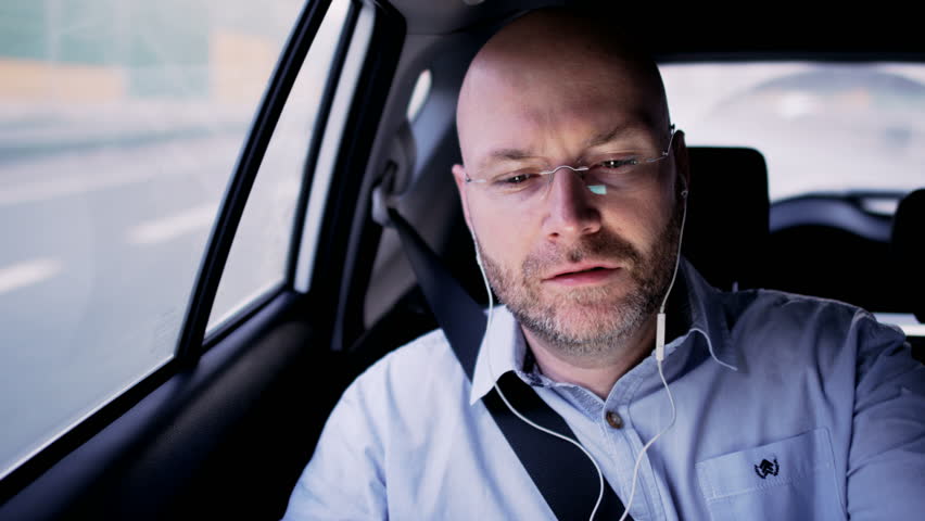 Bald Businessman in the Car Having a Skype Call | Shutterstock HD Video #33874054