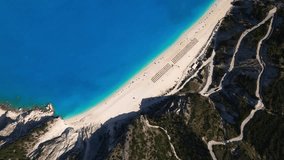 Flying over Myrtos beach, Kefalonia, during the summer, Greek Ionian Islands. 4k drone video..