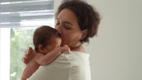 A loving mother takes care of her newborn baby. Mom holding a crying baby in her arms. Mother hugs her little, newborn son - Powered by Shutterstock - Get 15% off with code: PIKWIZARD15